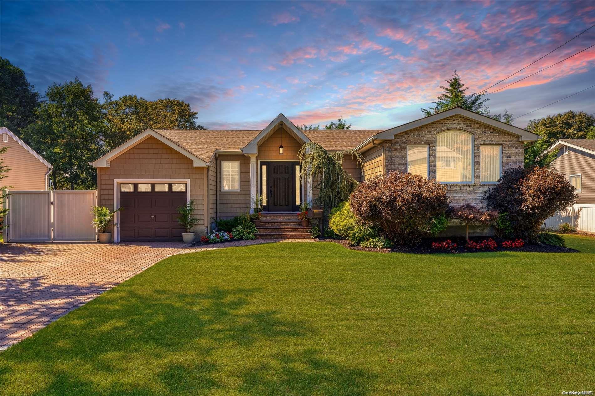 a front view of a house with a garden