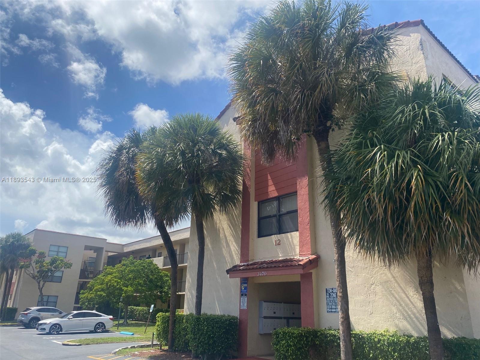 a palm tree sitting in front of a building