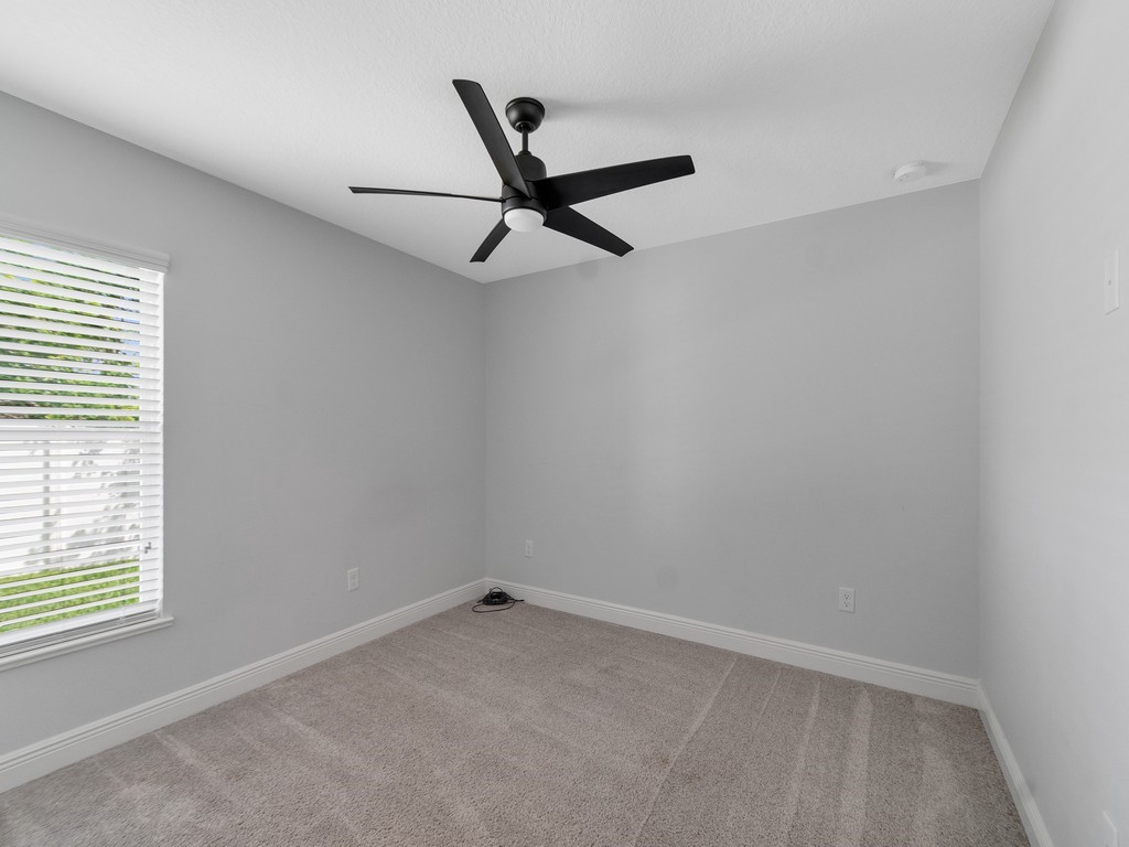 431 Midvale Terrace Sebastian, FL 32958 - Photo 23 of 34 an empty room with a window and a ceiling fan