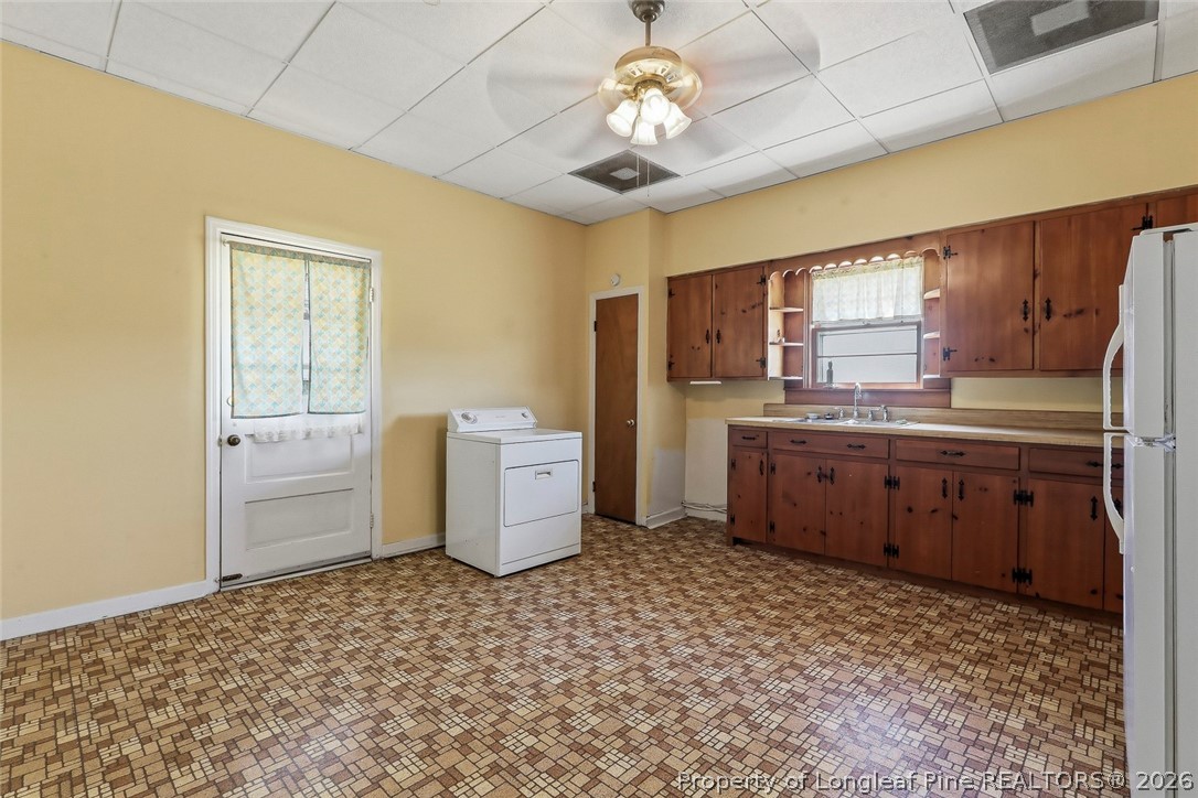 249 Nicholson Road Rockingham, NC 28379 - Photo 22 of 47 a kitchen with a stove a sink and a refrigerator