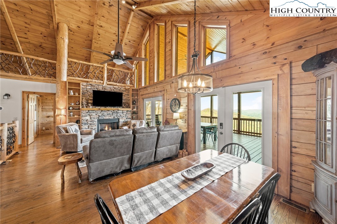 196 Eagle Nest Road Purlear, NC 28665 - Photo 16 of 36 a living room with furniture a fireplace and a table