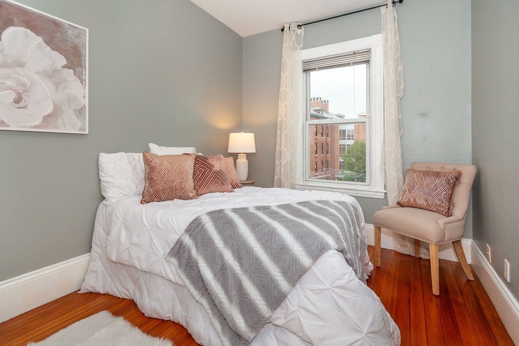 797 Columbia Road, Unit 3 Boston, MA 02125 - Photo 11 of 18 a bedroom with a bed and a couch