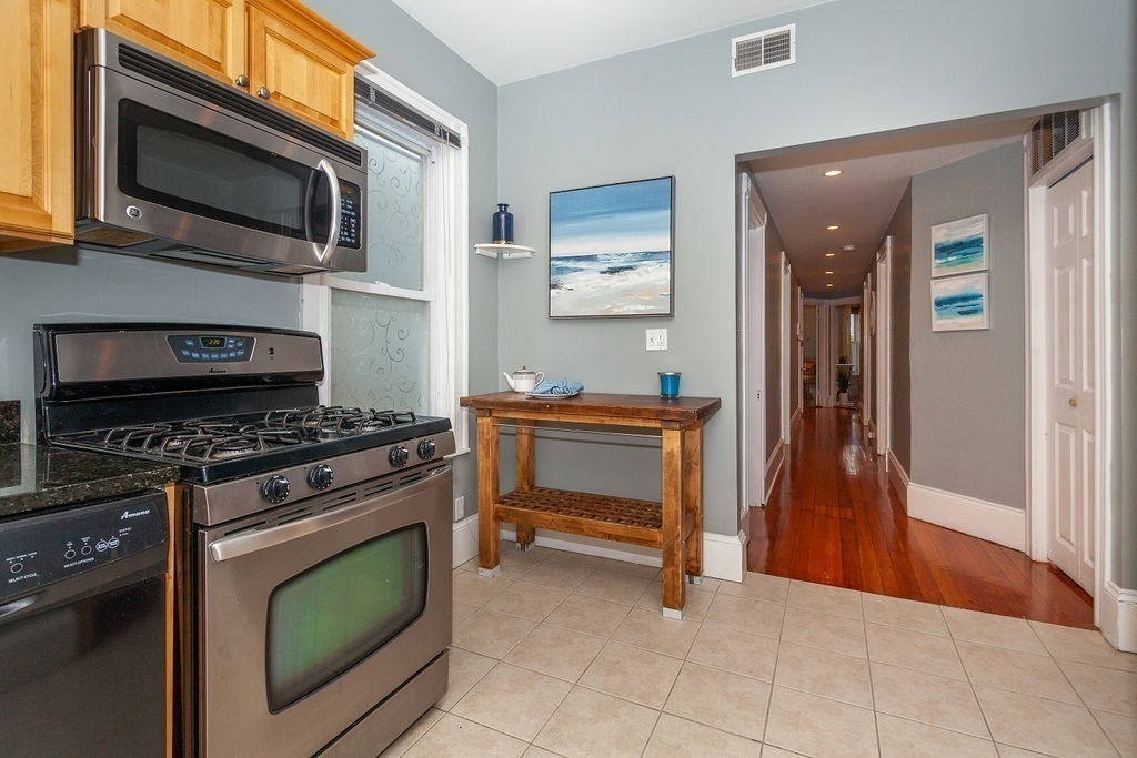 797 Columbia Road, Unit 3 Boston, MA 02125 - Photo 2 of 18 a kitchen with a stove and a microwave