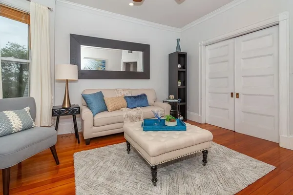 a living room with furniture and wooden floor