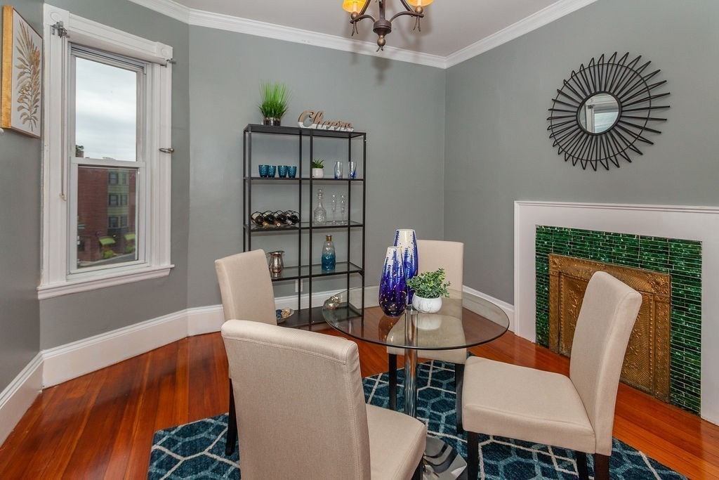 797 Columbia Road, Unit 3 Boston, MA 02125 - Photo 7 of 18 a dining room with furniture and wooden floor