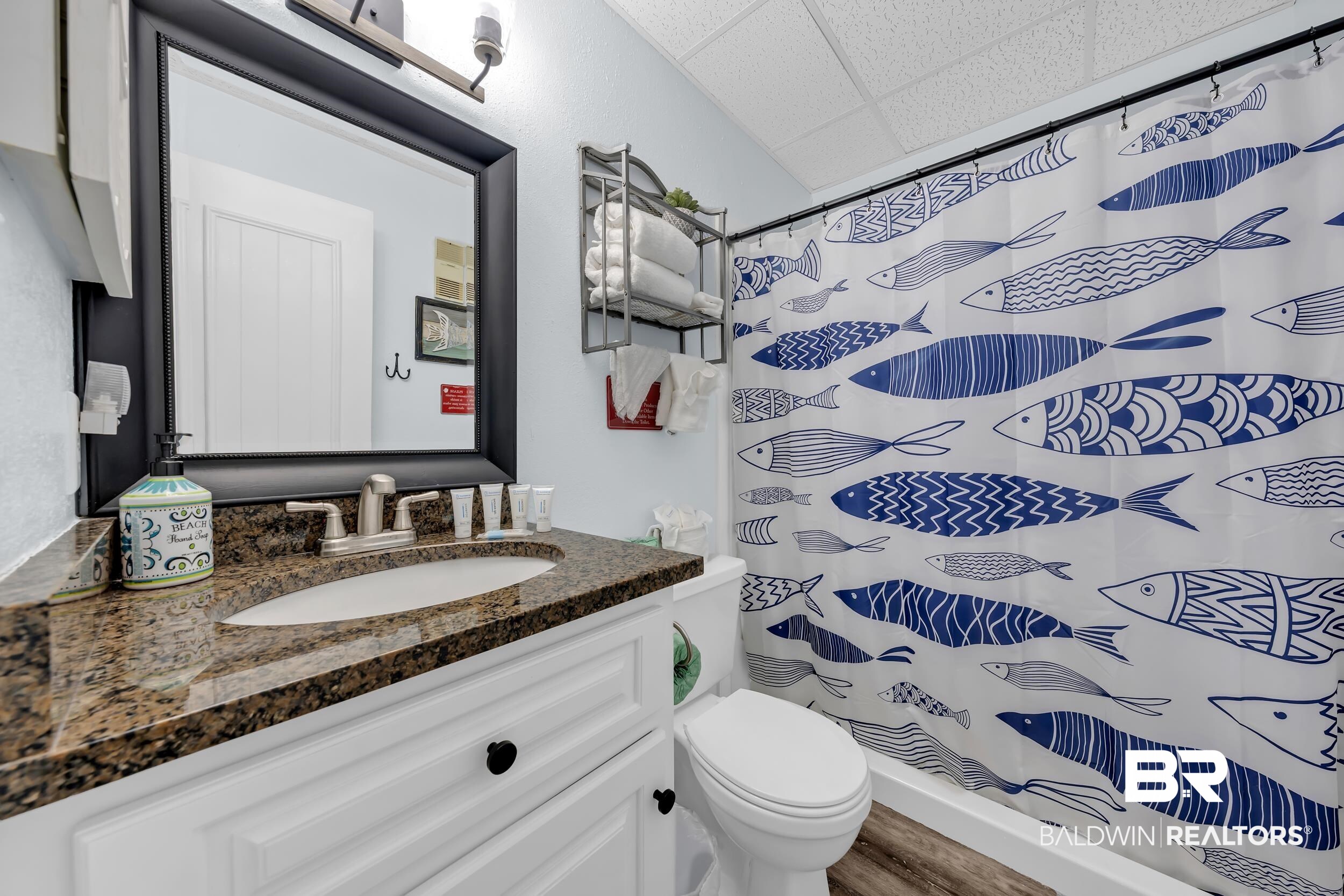 400 Plantation Road, Unit 2118 Gulf Shores, AL 36542 - Photo 21 of 59 Bathroom featuring a vanity with a dark speckled countertop, an undermount sink, and a framed mirror