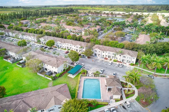 an aerial view of residential houses with outdoor space