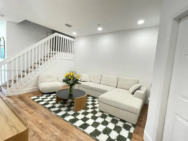 a living room with furniture and a rug