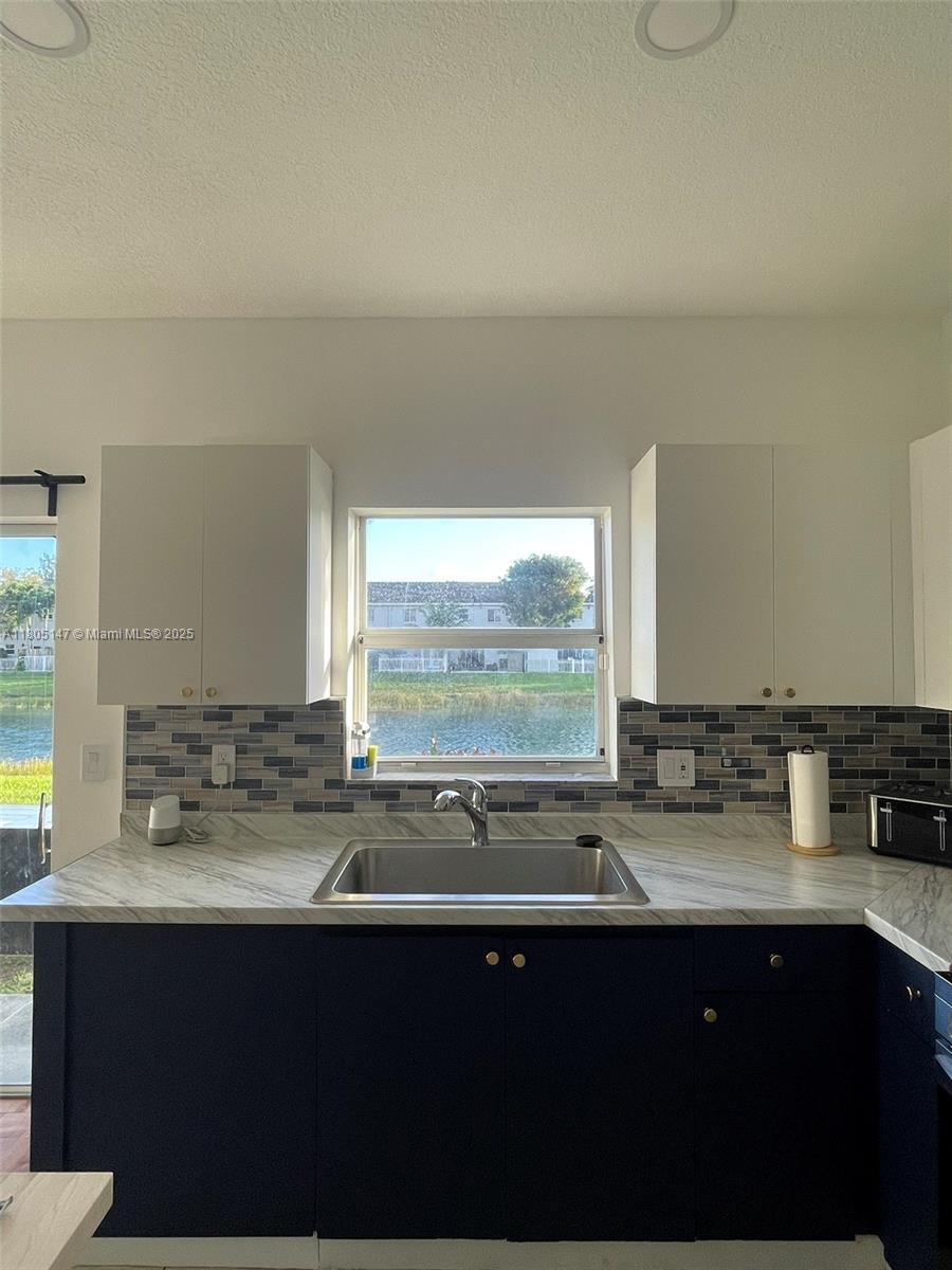 1636 Southeast 30th Street, Unit 1636 Homestead, FL 33035 - Photo 7 of 12 a sink with a large mirror next to a window
