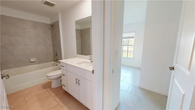 a bathroom with a double vanity sink toilet and shower