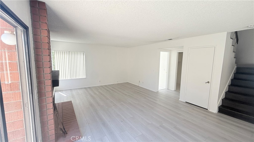 46 Christamon West Irvine, CA 92620 - Photo 16 of 65 a view of an empty room with wooden floor and a window