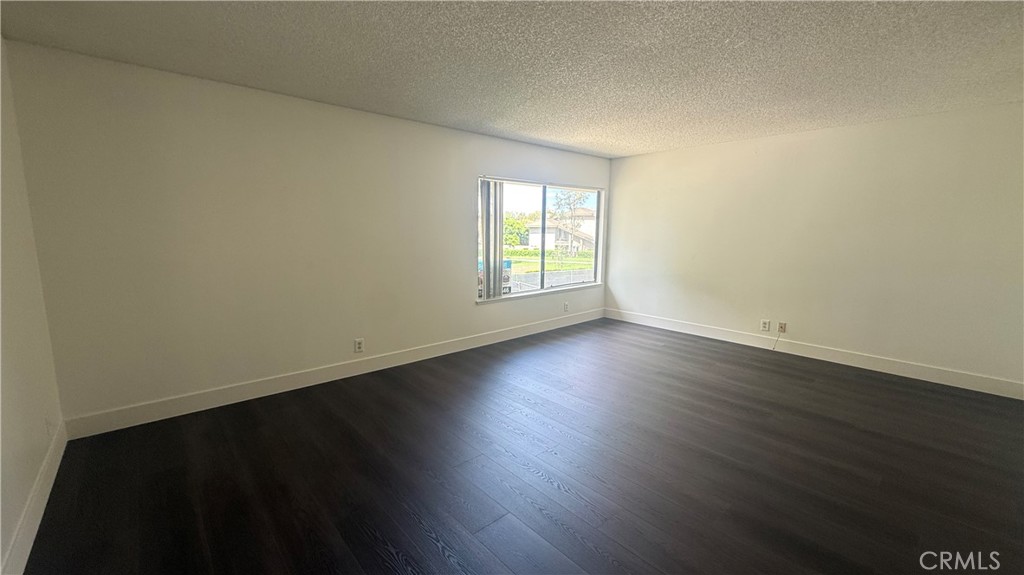 46 Christamon West Irvine, CA 92620 - Photo 32 of 65 a view of an empty room with wooden floor and a window