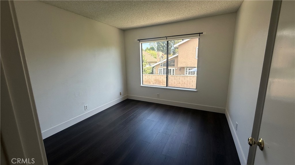 46 Christamon West Irvine, CA 92620 - Photo 39 of 65 an empty room with wooden floor and windows