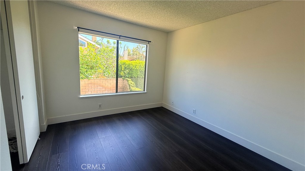 46 Christamon West Irvine, CA 92620 - Photo 45 of 65 an empty room with wooden floor and a window