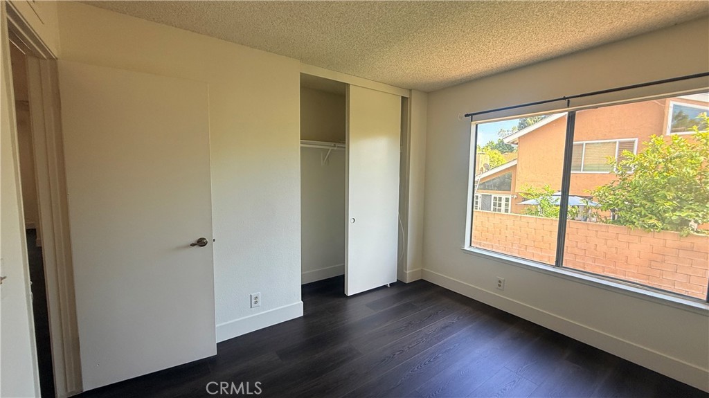 46 Christamon West Irvine, CA 92620 - Photo 47 of 65 a view of an empty room with wooden floor and a window