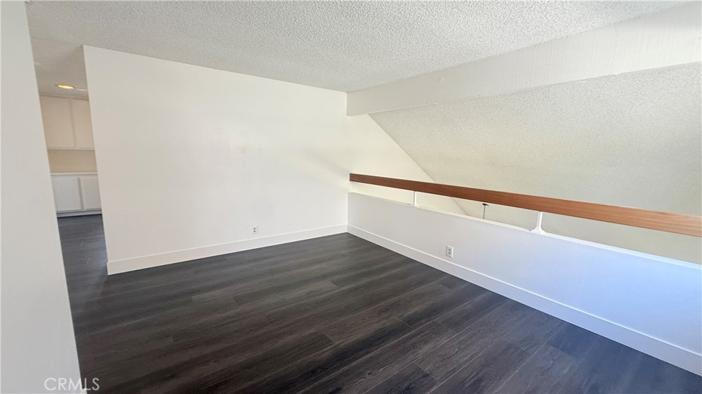46 Christamon West Irvine, CA 92620 - Photo 54 of 65 a view of an empty room with wooden floor