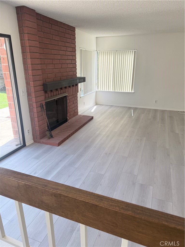 46 Christamon West Irvine, CA 92620 - Photo 60 of 65 an empty room with wooden floor and fireplace