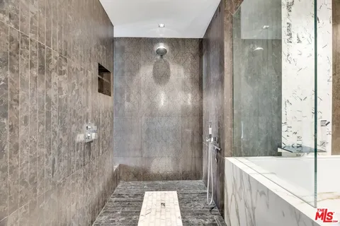 a view of a hallway with wooden floor and windows