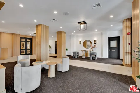a living room with dining room and wooden floor