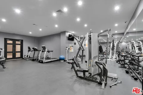 a living room filled with furniture and floor to ceiling window