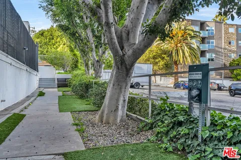 a living room with furniture a flat screen tv and a floor to ceiling window