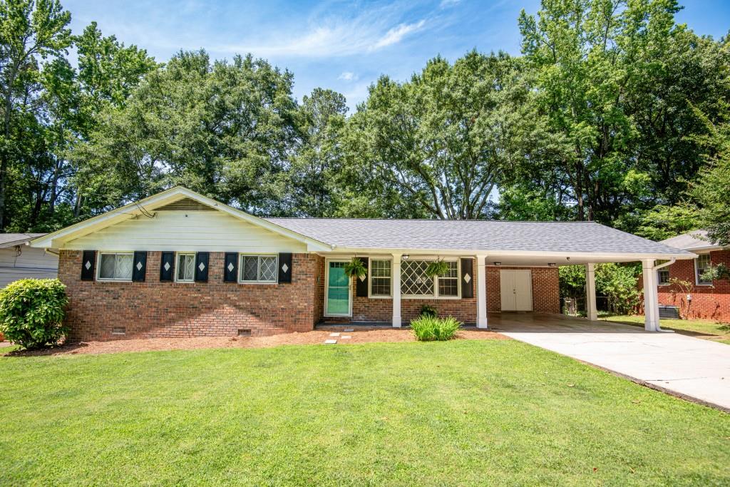 4106 North Shallowford Road Atlanta, GA 30341 - Photo 1 of 1 a front view of a house with a garden and plants