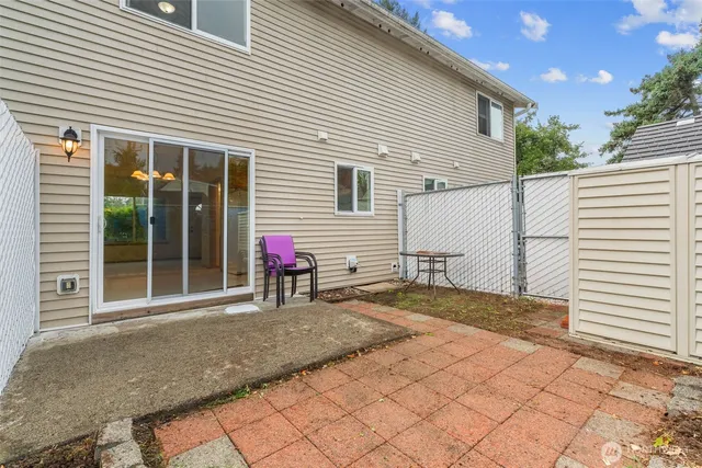a view of a white house with a small yard and a large window