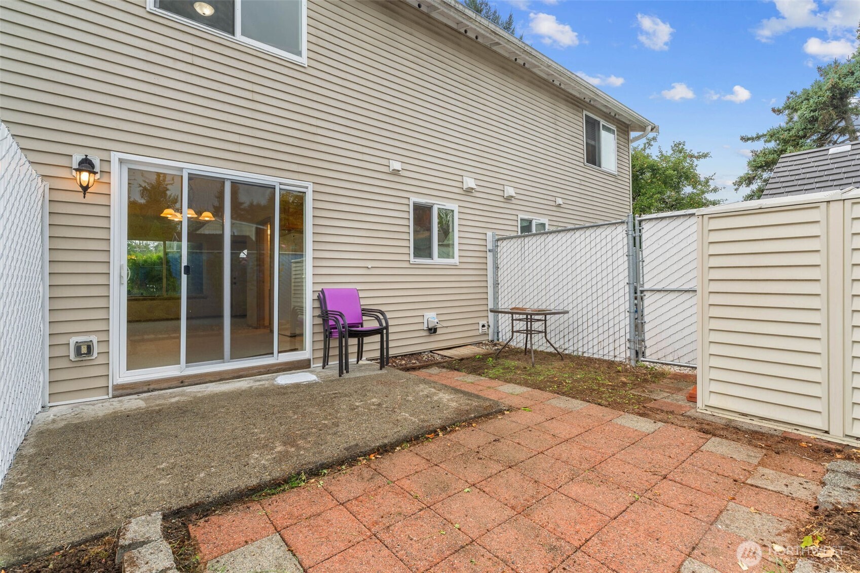 14510 West Throne Lane Southwest Lakewood, WA 98498 - Photo 21 of 28 a view of a white house with a small yard and a large window