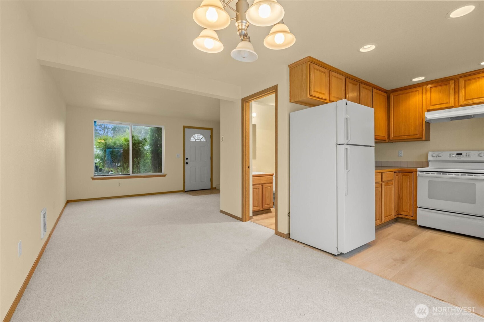 14510 West Throne Lane Southwest Lakewood, WA 98498 - Photo 5 of 28 a view of a kitchen with a refrigerator a microwave and a sink