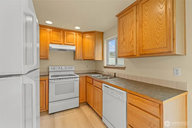 a kitchen with a sink stove and cabinets