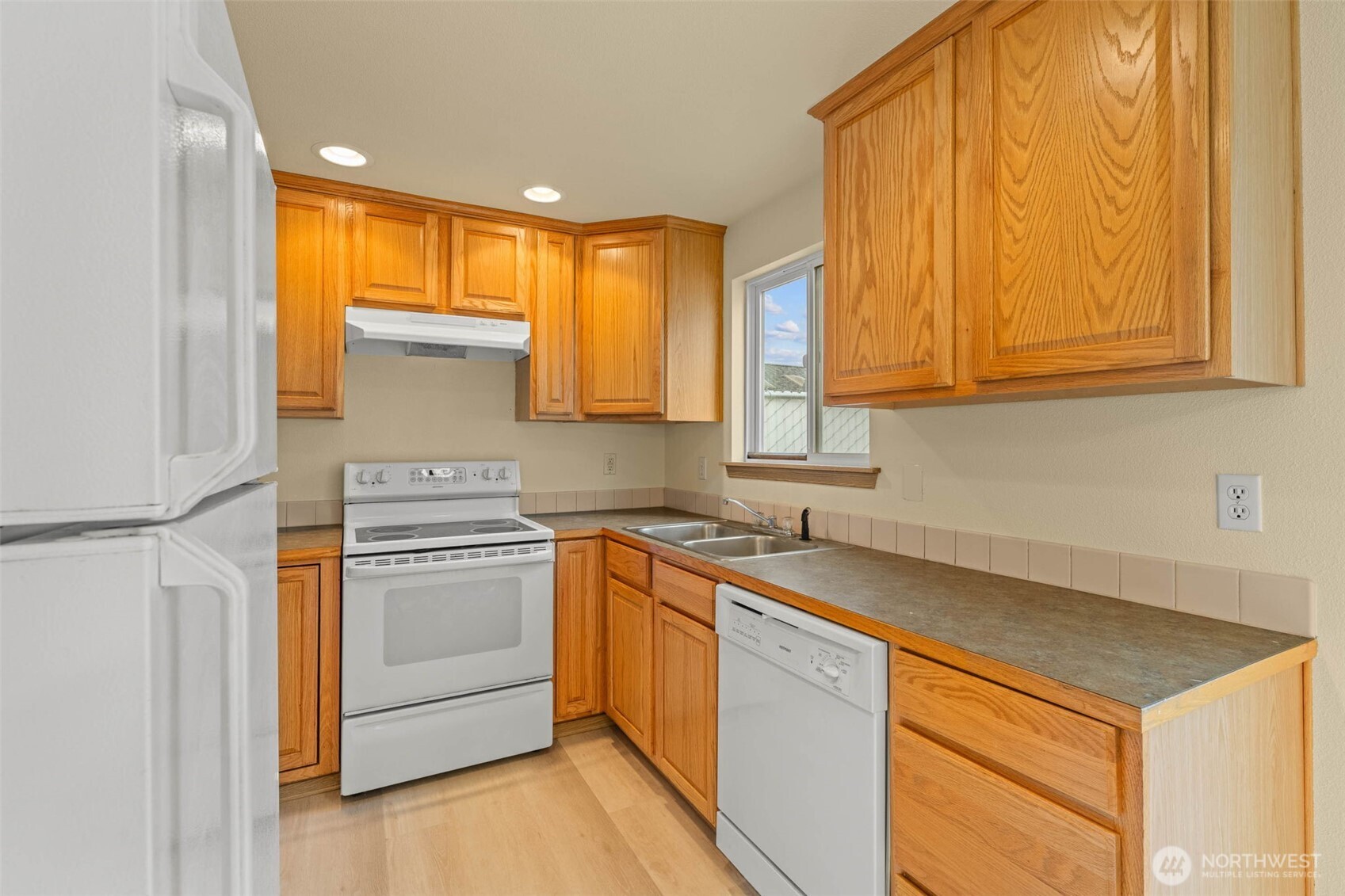 14510 West Throne Lane Southwest Lakewood, WA 98498 - Photo 6 of 28 a kitchen with a sink stove and cabinets