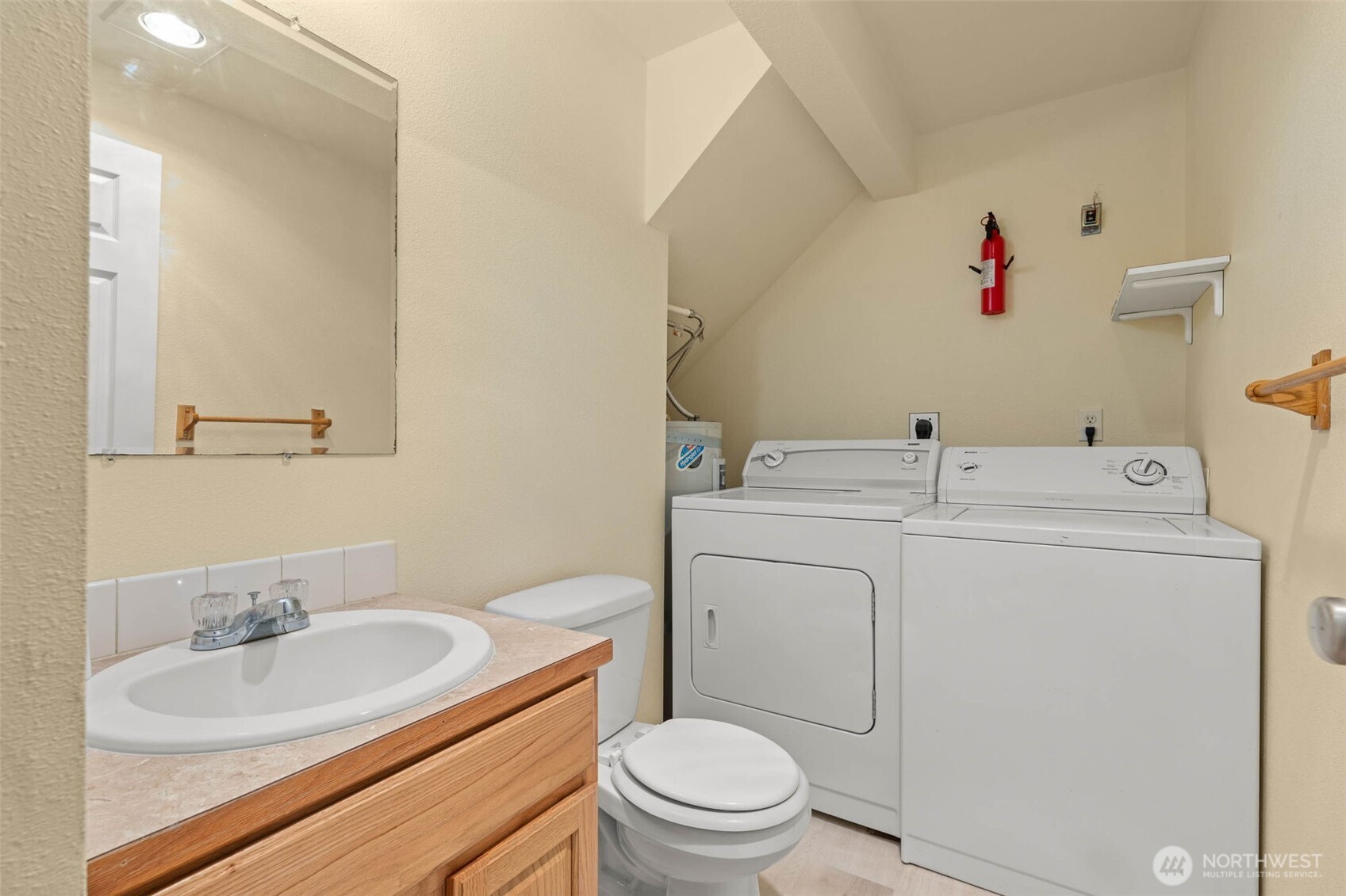 14510 West Throne Lane Southwest Lakewood, WA 98498 - Photo 10 of 28 a bathroom with a toilet sink vanity and mirror