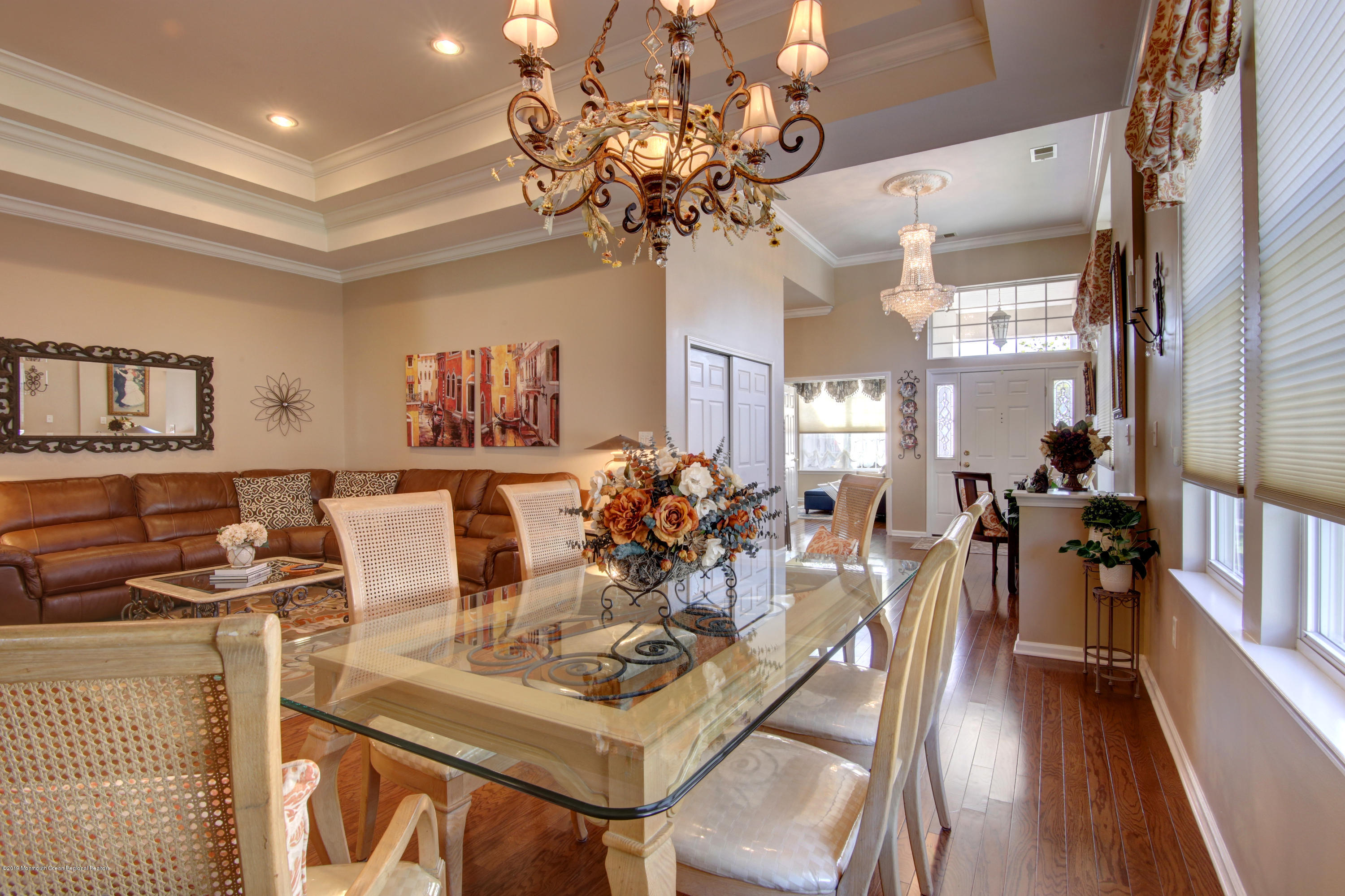 25 Hartack Road Manalapan, NJ 07726 - Photo 3 of 20 a view of a dining room with furniture a chandelier and wooden floor