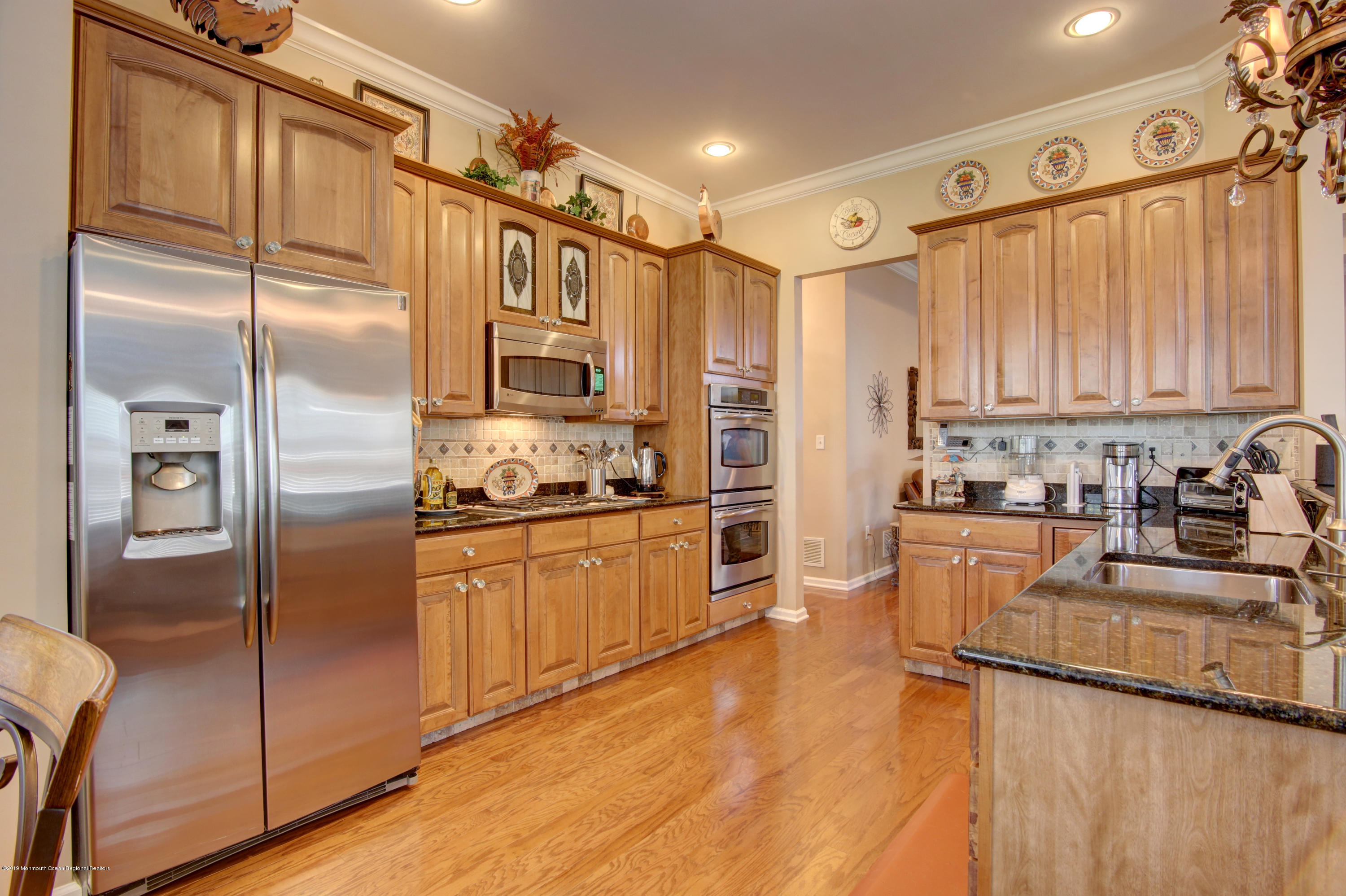 25 Hartack Road Manalapan, NJ 07726 - Photo 5 of 20 a kitchen with stainless steel appliances granite countertop a refrigerator a sink and white cabinets