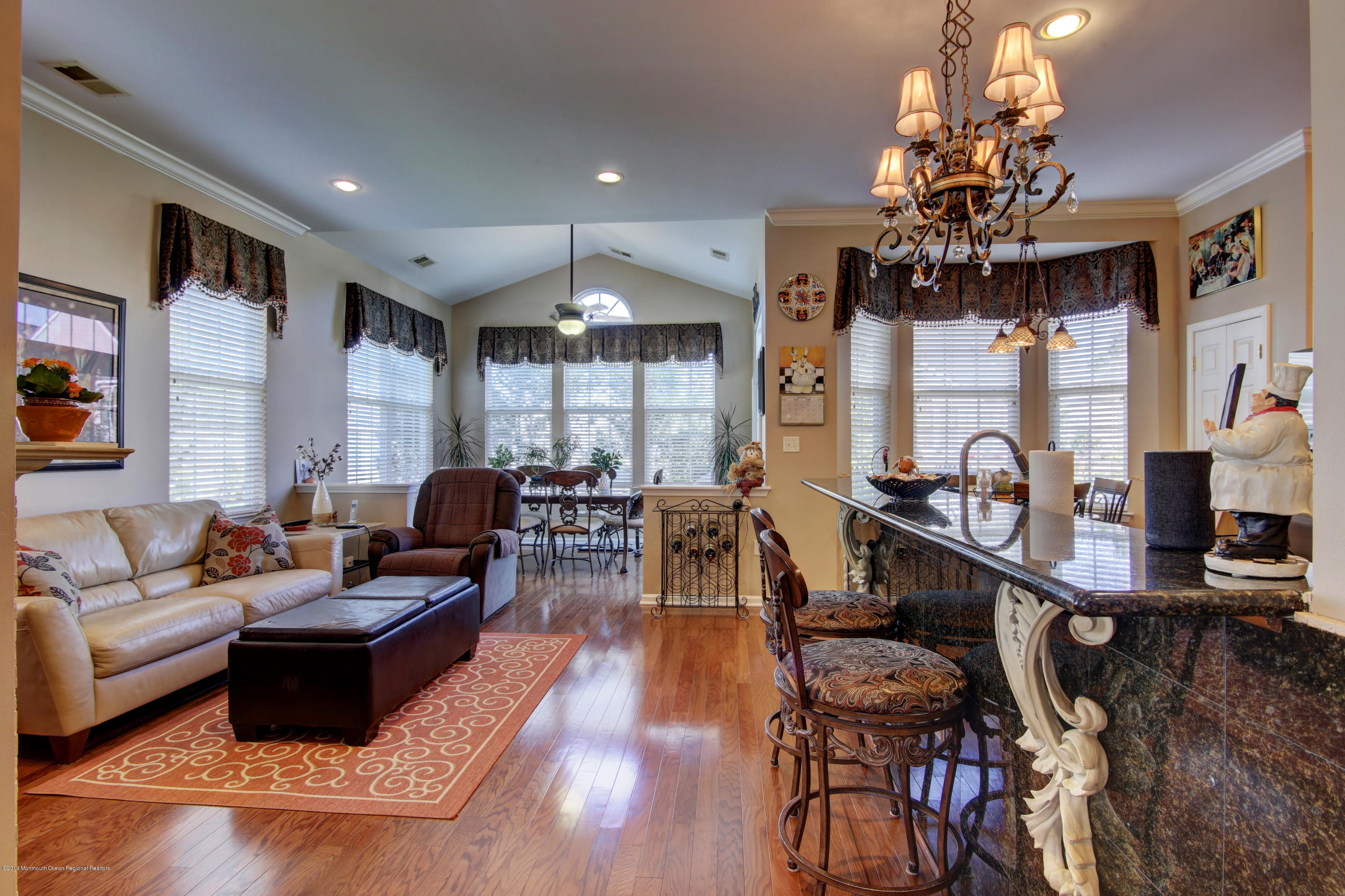 25 Hartack Road Manalapan, NJ 07726 - Photo 6 of 20 a living room with furniture a chandelier and a large window