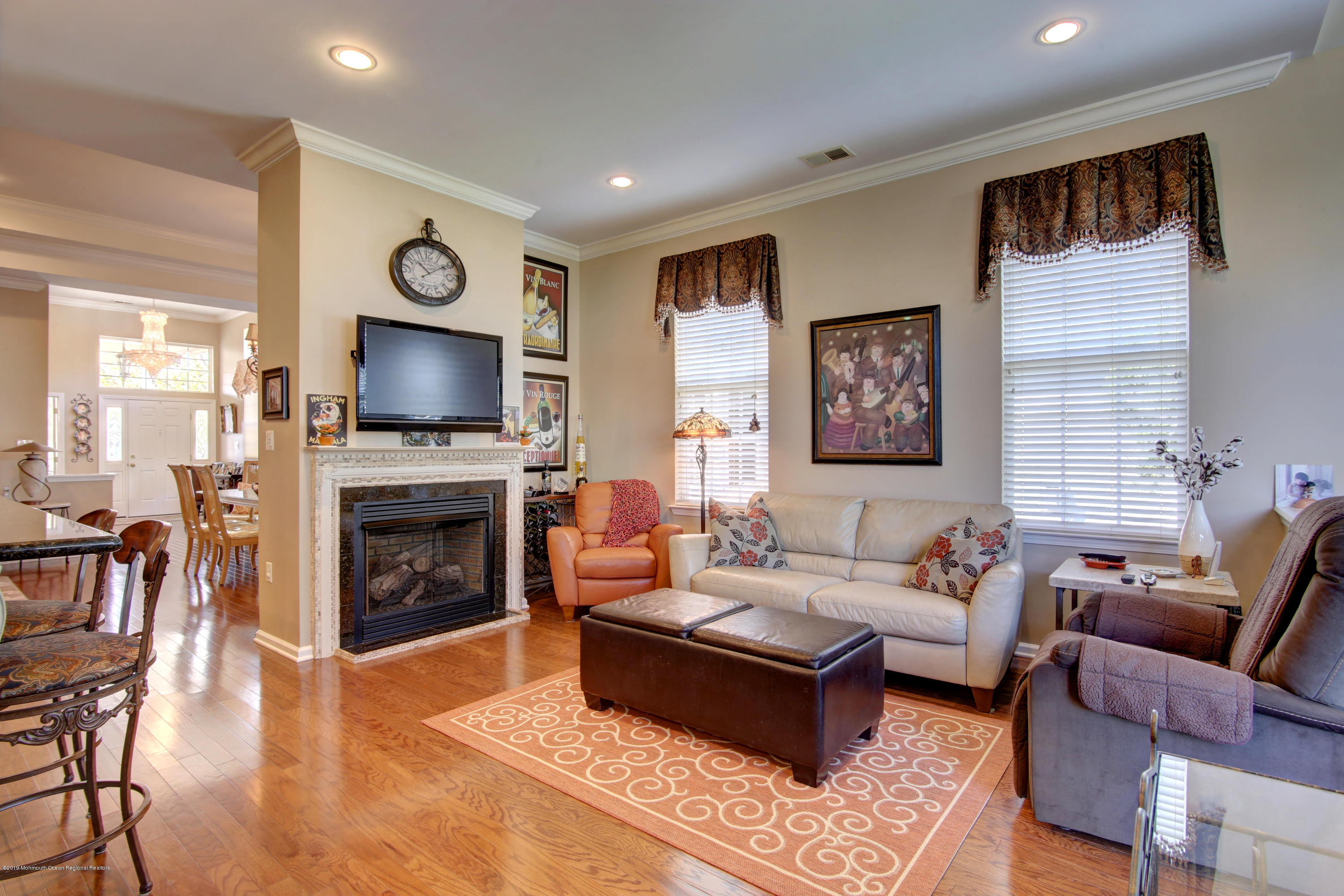 25 Hartack Road Manalapan, NJ 07726 - Photo 7 of 20 a living room with furniture a fireplace and a flat screen tv