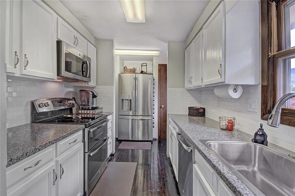 627 Deer Path Road Dillon, CO 80435 - Photo 12 of 25 a kitchen with stainless steel appliances granite countertop a sink stove microwave and refrigerator