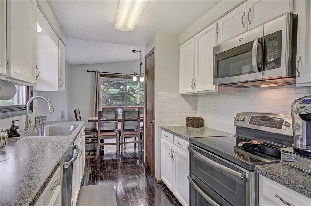 627 Deer Path Road Dillon, CO 80435 - Photo 13 of 25 a kitchen with stainless steel appliances granite countertop a stove microwave and sink