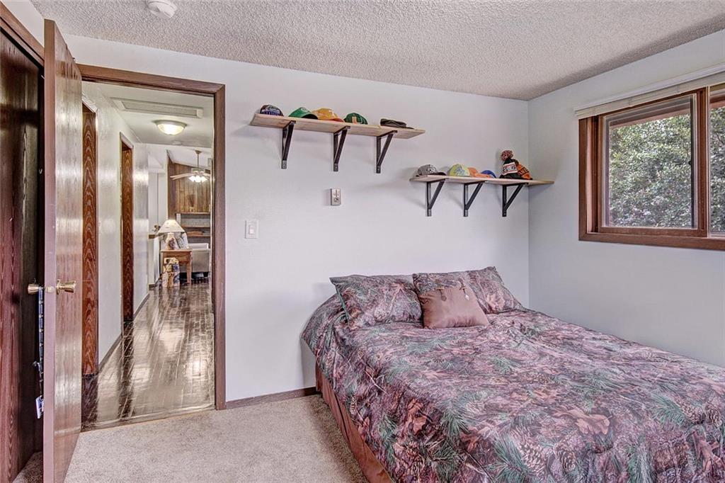 627 Deer Path Road Dillon, CO 80435 - Photo 17 of 25 a bedroom with a bed and a painting on the wall
