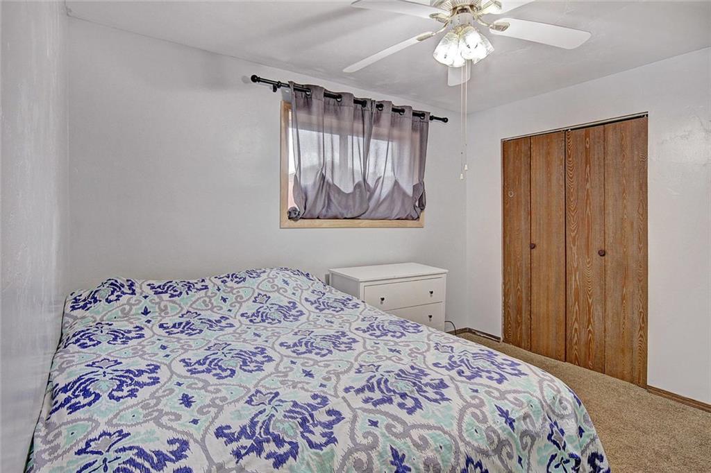 627 Deer Path Road Dillon, CO 80435 - Photo 22 of 25 a bedroom with a bed and a chandelier