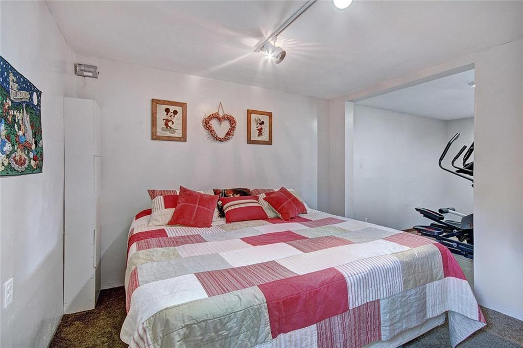 627 Deer Path Road Dillon, CO 80435 - Photo 24 of 25 a bedroom with a bed and a painting on the wall