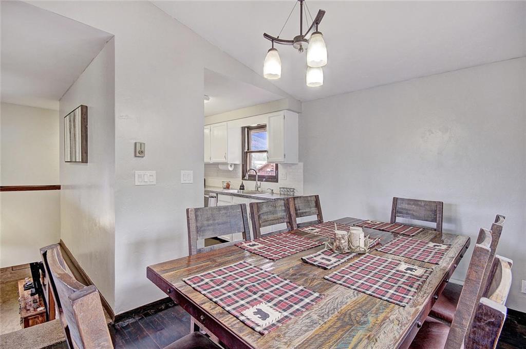 627 Deer Path Road Dillon, CO 80435 - Photo 8 of 25 a living room with a dining table and paintings on the wall