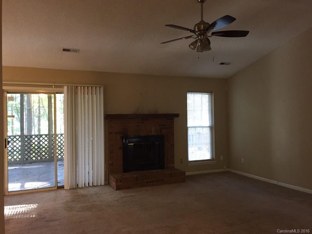 700 Southland Road Huntersville, NC 28078 - Photo 2 of 16 a view of an empty room with a window and a ceiling fan