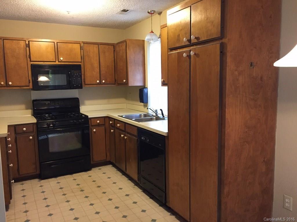 700 Southland Road Huntersville, NC 28078 - Photo 5 of 16 a kitchen with stainless steel appliances granite countertop a stove a refrigerator and a sink