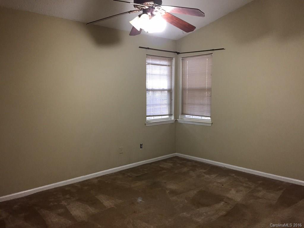 700 Southland Road Huntersville, NC 28078 - Photo 10 of 16 an empty room with window and chandelier fan