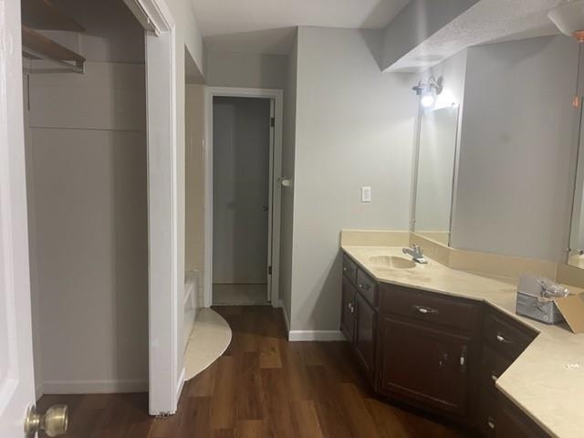 5843 Ridgehill Drive Memphis, TN 38141 - Photo 4 of 6 Full bathroom featuring double vanity, dark wood-style floors, and a bath