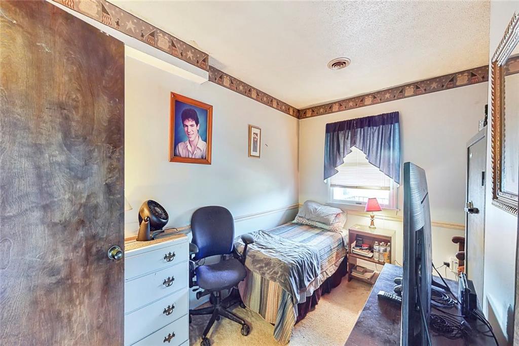 504 North Eighty Eight Road Carmichaels, PA 15320 - Photo 24 of 25 a bedroom with a bed and wooden floor