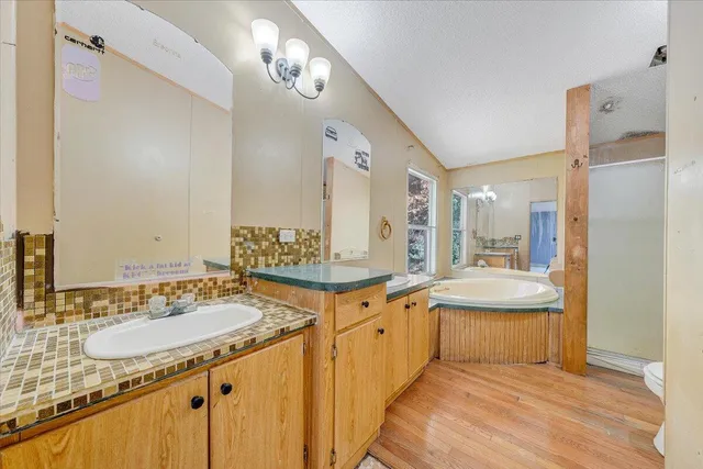 a large bathroom with a sink double vanity granite and a mirror