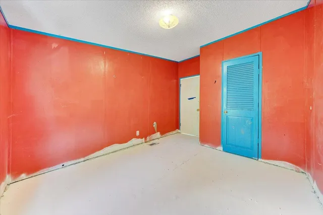 a bed room with a bed and a large window