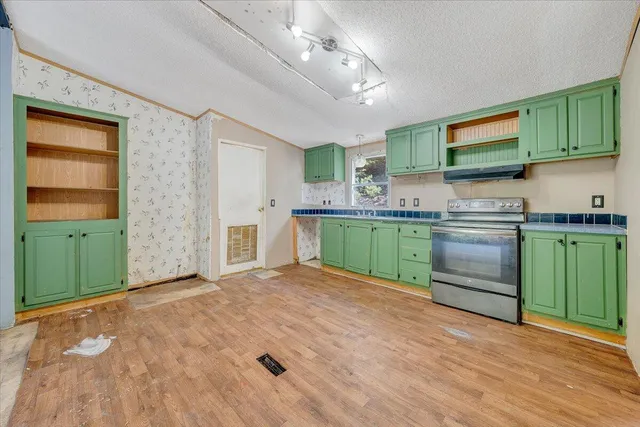 a kitchen with stainless steel appliances granite countertop a sink and cabinets